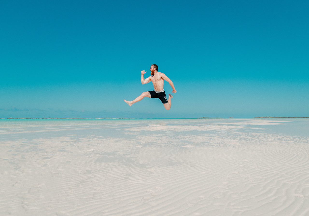 Man Jumping On Beach