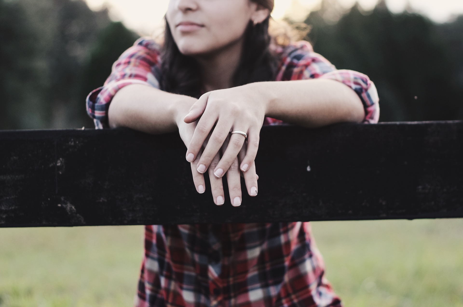 woman hands on fence